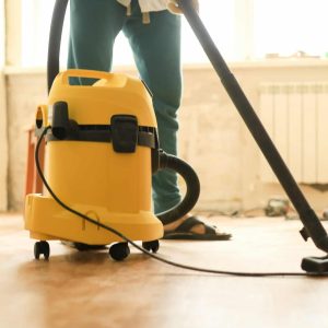 a-man-is-cleaning-the-room-during-repairs-using-a-construction-vacuum-cleaner.jpg