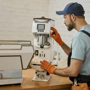 repairman-checking-professional-coffee-maker-in-cafe.jpg